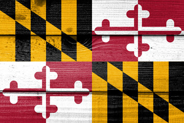 maryland flag painted on old wood plank background. Brushed natural light knotted wooden board texture. Wooden texture background flag of maryland