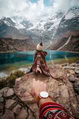 A young couple on vacation sitting on the rocks at Laguna Humantay, Peru © marina