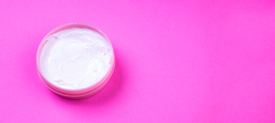 Obraz na płótnie Canvas Beauty cream jar on pink background