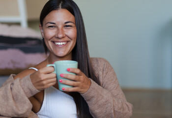 Happy woman day dreaming during coffee time at home.