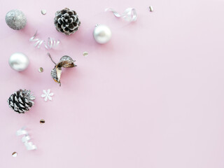 Silver Christmas decorations on a pink background, pattern, ornament. Gentle new year's concept, flat lay, top view, copy space. Christmas monochrome composition