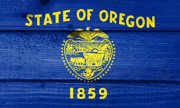 oregon flag painted on old wood plank background. Brushed natural light knotted wooden board texture. Wooden texture background flag of oregon