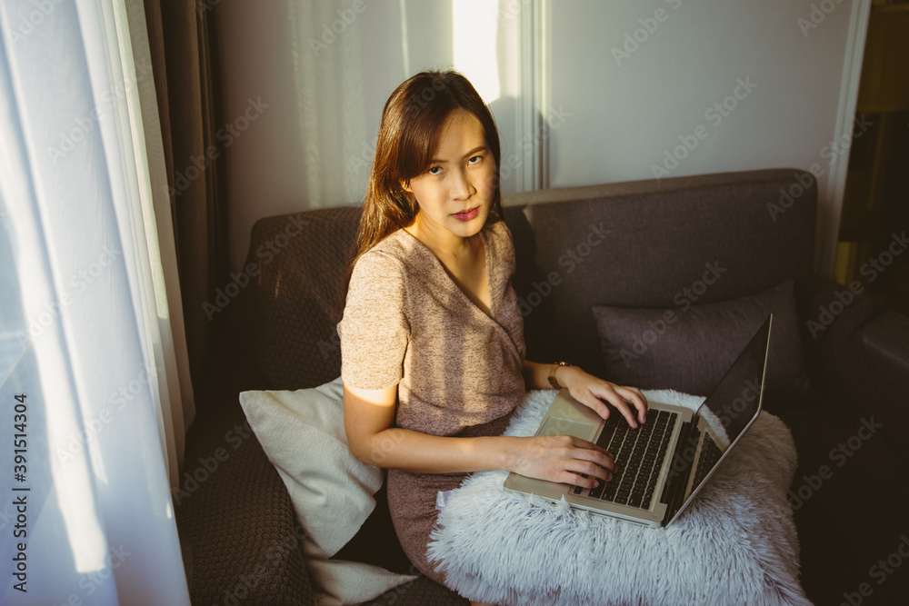 Wall mural asian business woman working and typing on laptop keyboard