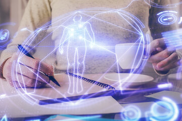 Education theme hologram over woman's hands writing background. Concept of study. Double exposure
