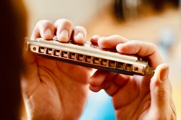 hand holding a harmonica