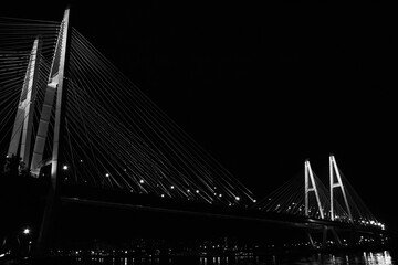 suspension bridge at night black and white