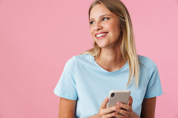 Smiling attractive young woman using mobile phone