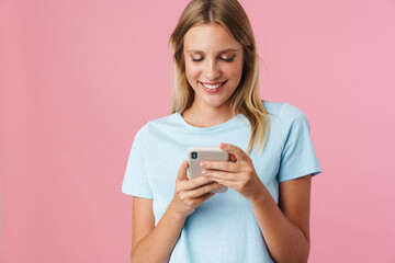 Smiling attractive young woman using mobile phone