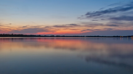 Fototapeta na wymiar Sunset full of colors at the Pogoria III Lake.