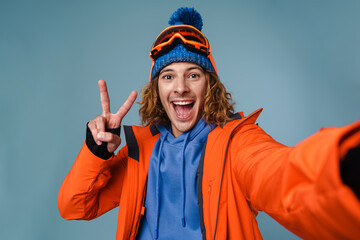 Handsome happy sportsman taking selfie on cellphone