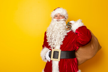 Fototapeta na wymiar Santa Claus holding a sack filled with Christmas presents