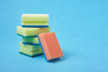 dishwashing sponges on blue background copy sapce