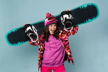 Happy sportswoman posing with snowboard isolated