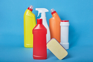 various types of white plastic bottles without labels for detergents on a light blue background top view copy space