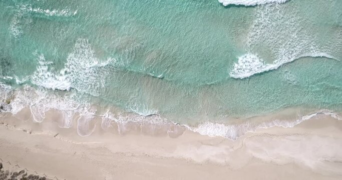 4k Birds Eye View of incredible beach and waves with foam in Formentera