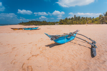 Fototapeta na wymiar Beach with blue boats, tropical landscape. Summer vacation