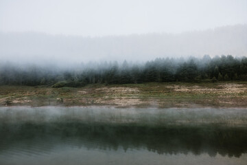 Foggy early morning on the mountain lake