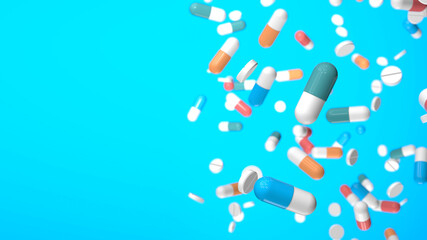 Colored pills and capsules on a blue background. Copy space for text. 3d render