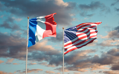 Beautiful national state flags of France and USA together at the sky background. 3D artwork concept.