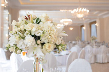 a bouquet of white flowers on the table. Decoration flower wedding table.