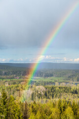 Beautiful rainbow as rain is coming down on a sunny day