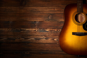 Acoustic guitar on wooden background. Copy space. Top view