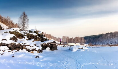 Winter landscape with frozen river, snow, rocks and trees