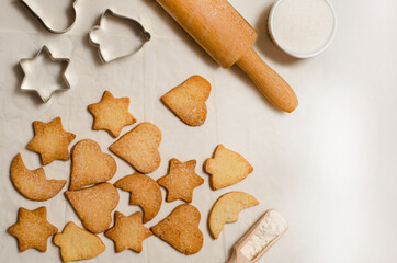 Christmas homemade gingerbread cookies on a white table top view.   Festive homemade gingerbread cookies. Christmas time. Traditional Christmas cookies