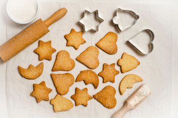 Christmas homemade gingerbread cookies on a white table top view.   Festive homemade gingerbread cookies. Christmas time. Traditional Christmas cookies