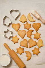 Christmas homemade gingerbread cookies on a white table top view.   Festive homemade gingerbread cookies. Christmas time. Traditional Christmas cookies