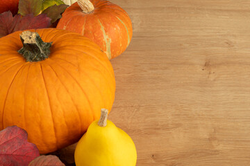 Composition of pumpkins and autumn leaves. Autumn still life. Halloween holiday.