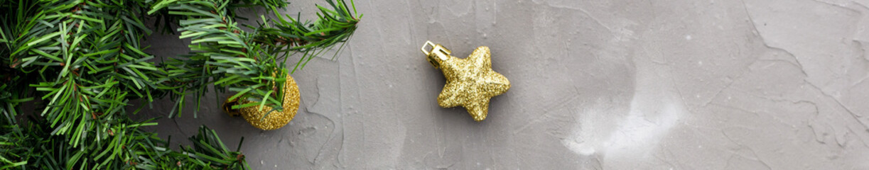 Banner of border of fir tree branches and golden Christmas balls and stars. Christmas holiday background