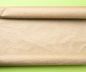 roll of brown parchment paper on a green background,