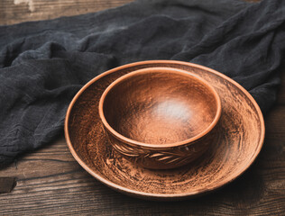 empty brown ceramic plates on a wooden table