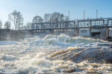 Water flushing from an open gate at a hydroelectric power plant