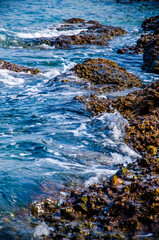 Ocean waves breaking on the rocks on the shore.