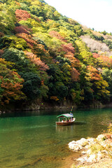Arashiyama in autumn season along the river. Beautiful place to experience nature in Kyoto, Japan.