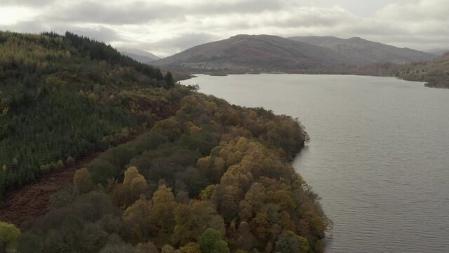 An aerial view looking down Loch Tay on an autumn day, Stirling, Scotland. Flying slowly down the loch towrds the town of Killin.