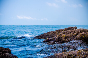 Ocean waves breaking on the rocks on the shore.