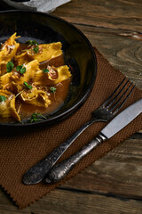 Italian ravioli stuffed with meat closeup on a black plate. rustic style