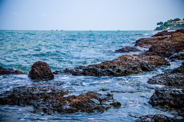 Ocean waves breaking on the rocks on the shore.