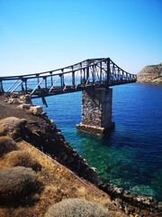 Fototapeta na wymiar bridge into nowhere / loading crane on the old mining island of Serifos, Greece