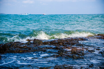 Ocean waves breaking on the rocks on the shore.