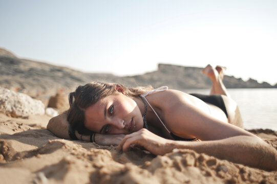 portrait of girl lying on a beach