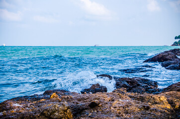 Ocean waves breaking on the rocks on the shore.