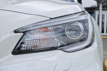 modern design headlamp on the front of a white car