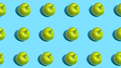 Fruit pattern of fresh green apples on blue background. Top view. Summer concept. Collage