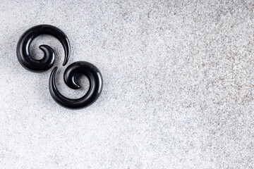 Jewelry for piercing on light background. Stock Image macro. Top view.