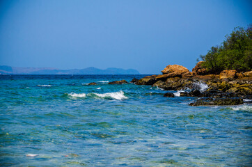 Ocean waves breaking on the rocks on the shore.