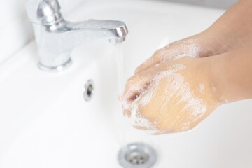 Bathroom faucets are used to wash their hands.